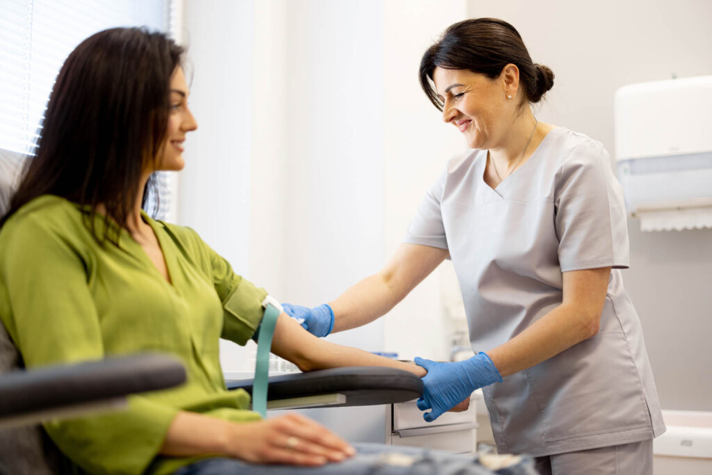 Nurse and patient preparing for blood test.