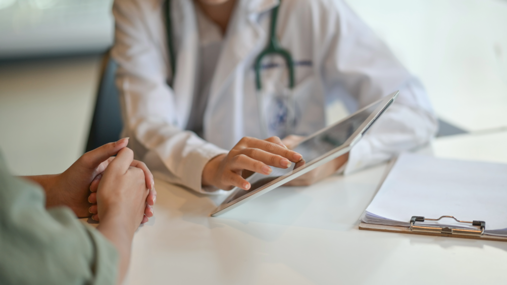 Doctor and patient looking at results on a tablet.